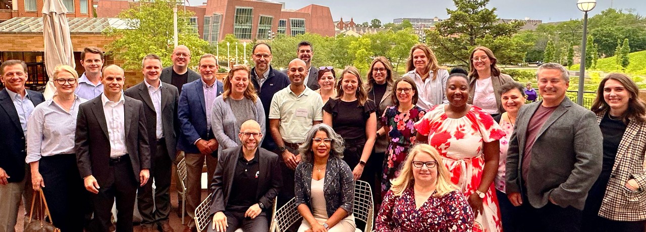 several adults on a rooftop pose for a photo