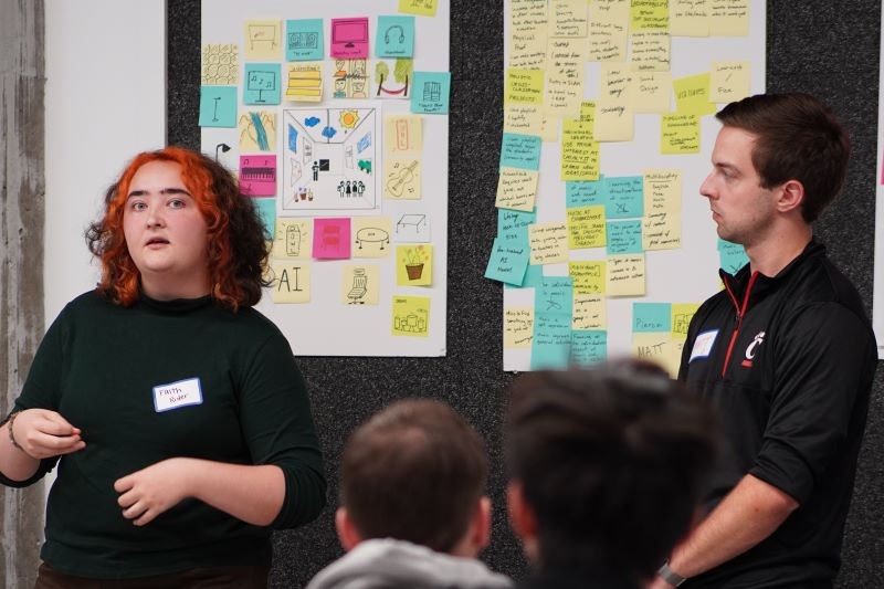 Two UC students present their ideas after a brainstorming session at 2023 CREATE event at the 1819 Innovation Hub.