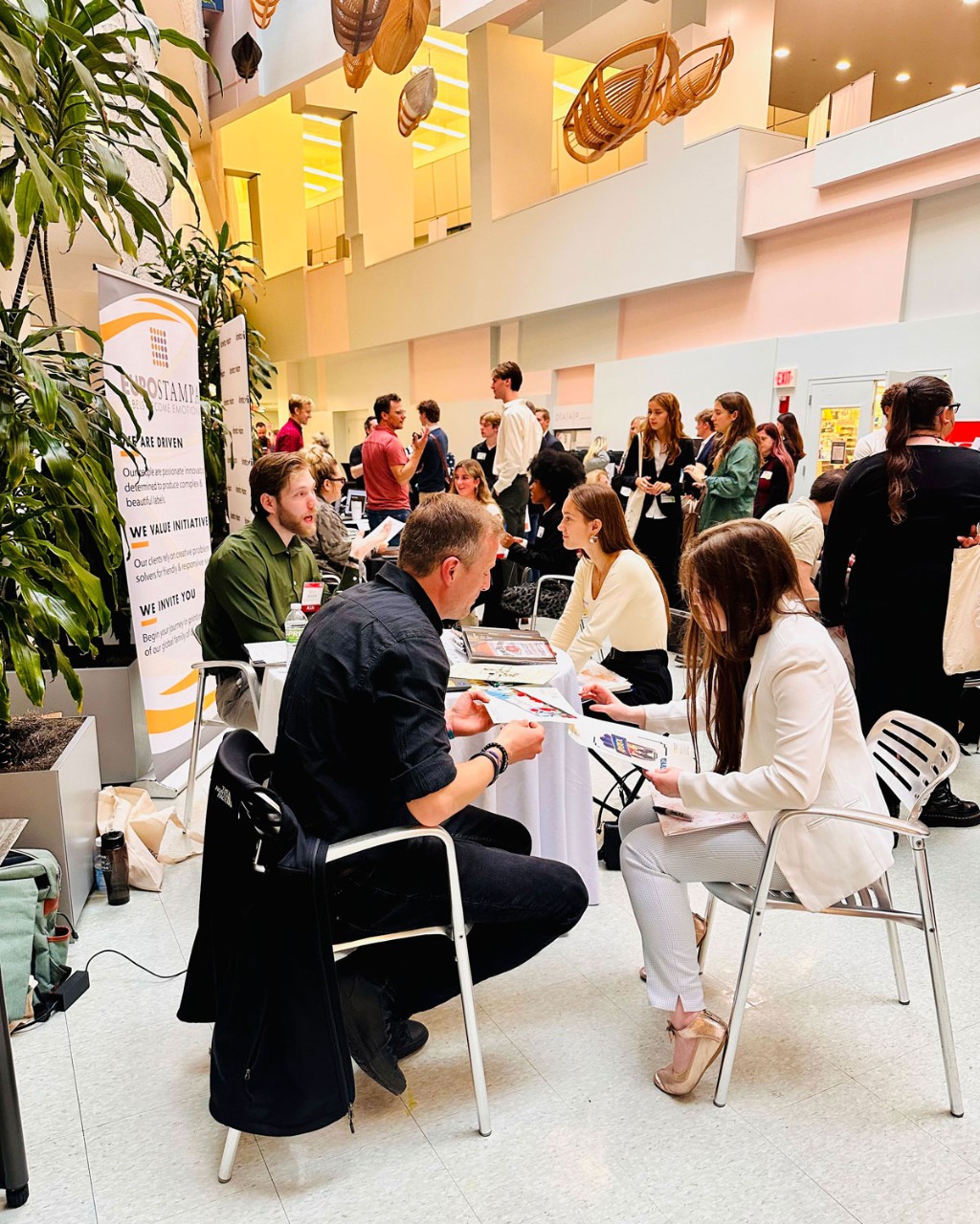 students at tables meeting with employers inside the DAAP cafe